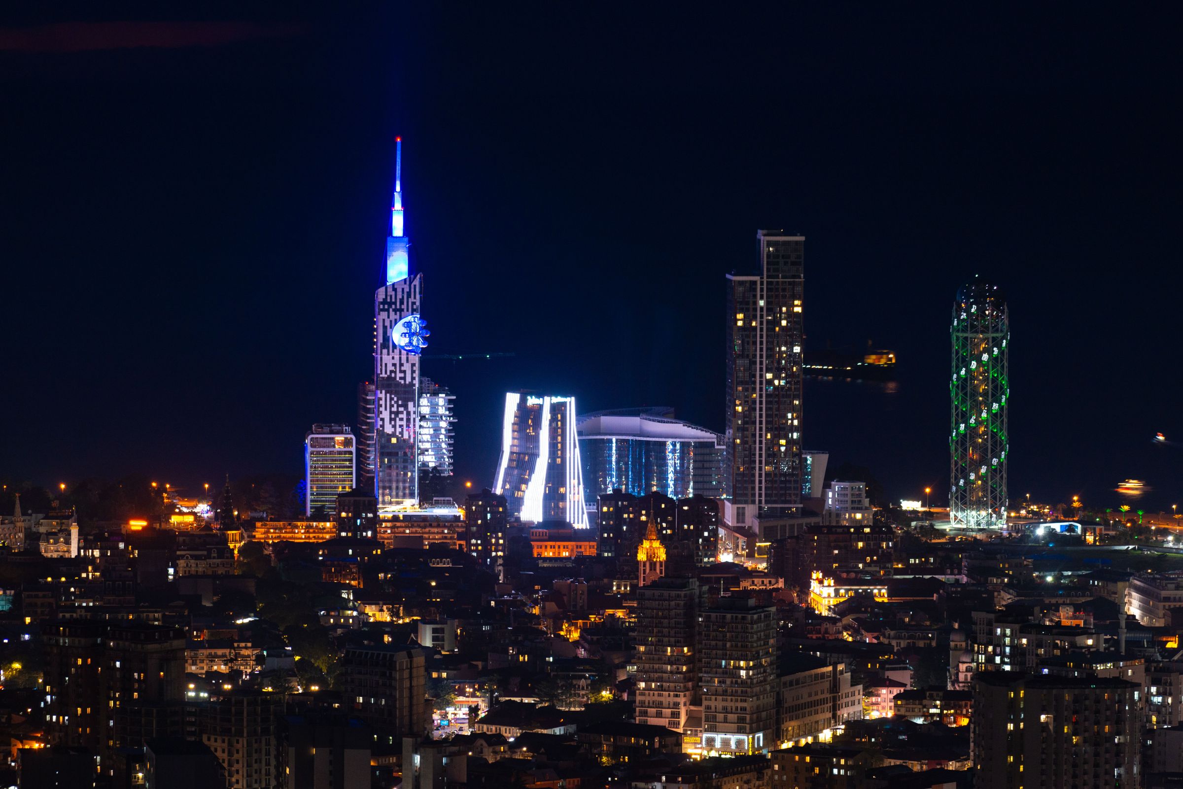 Batumi skyline at night, the same coast become abyss and gold windows.