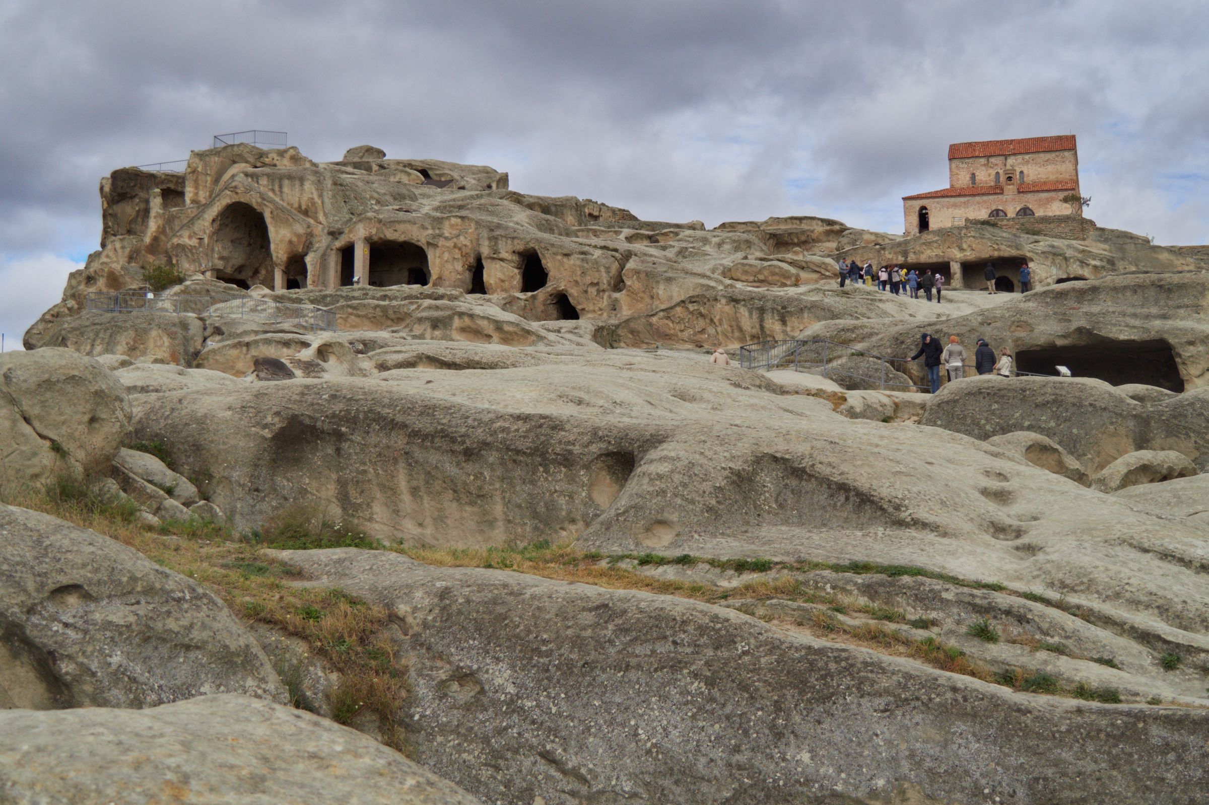 The rock-cut town of Uplistsikhe, rooms and wine-press hollows carved into a sun-struck ridge.
