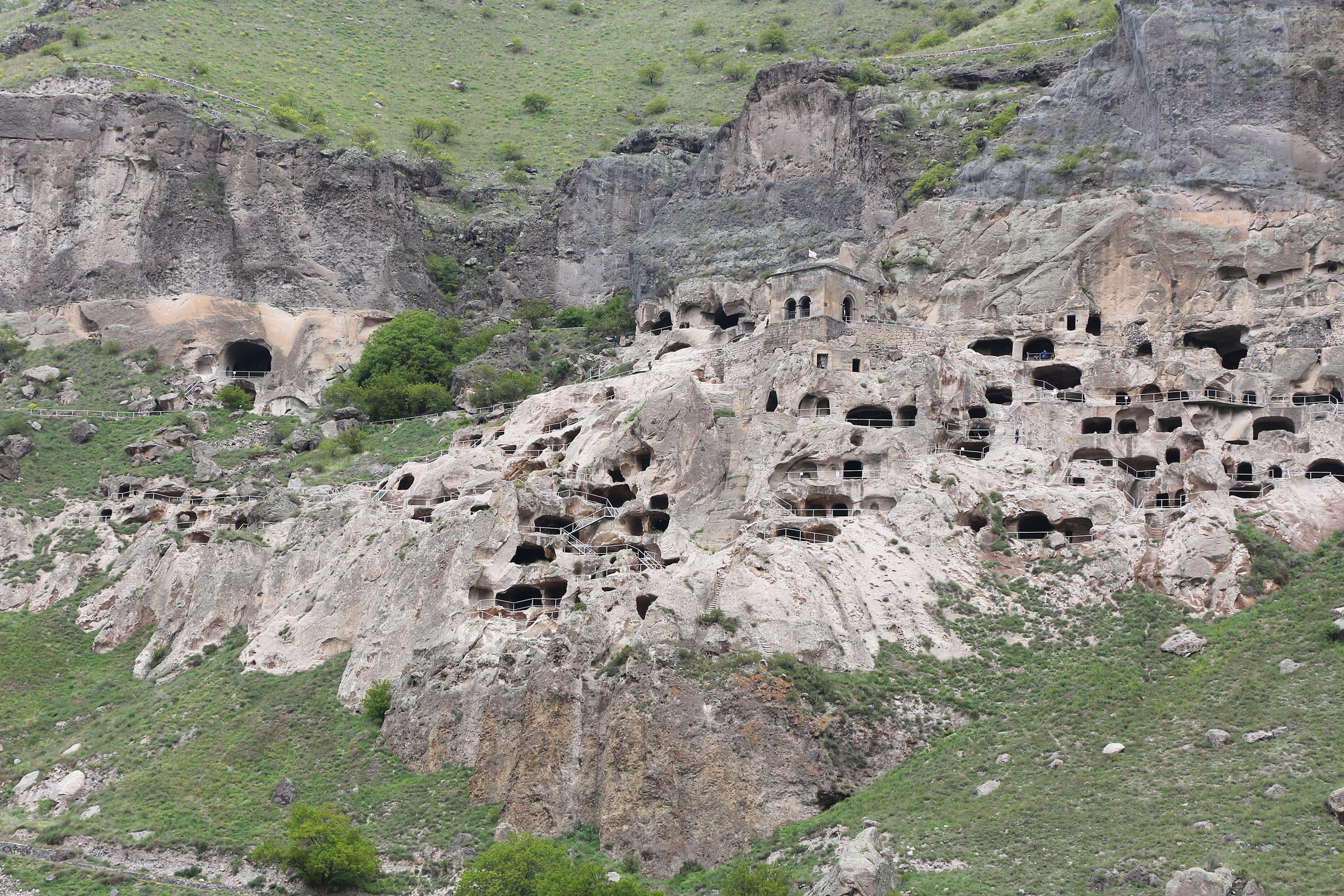 Vardzia cave monastery cut as a dark honeycomb into a sheer cliff of tuff.